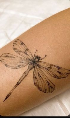 a woman's arm with a butterfly tattoo on it