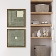 two pictures hanging on the wall next to baskets and other items in front of them