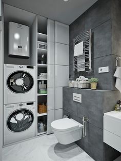 a bathroom with a toilet, washer and dryer in the middle of it