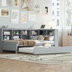 a bedroom with a bed, bookcase and dressers in it's center