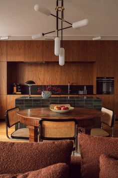 a wooden table sitting in the middle of a kitchen