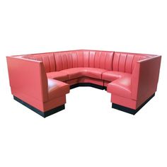 a red leather corner sofa sitting on top of a white floor