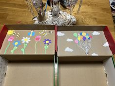 two boxes with flowers and balloons painted on them