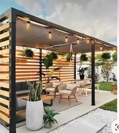 an outdoor living area with patio furniture and lighting