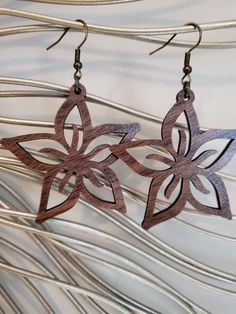 "-These lightweight beautiful flower dangle earrings are the perfect accessory for any outfit! Casual or dressy! -Made from finished solid walnut hardwood. 1/8 inch thickness. Measures 2.5\" Tall with ear wire. They are sturdy and made to last. -Custom made to order. -Hardware is nickel free & great for most sensitive ears. -Not recommended while swimming or bathing. -Please note this is a handmade item and variances in grain and wood colors are to be expected. -Free shipping with a $35 purchase Brown Bottles, Diy Cake Topper, Flower Dangle Earrings, Acrylic Shapes, Earrings Bridesmaid, Handmade Jewelry Gift, Wooden Earrings, Star Flower, Solid Walnut