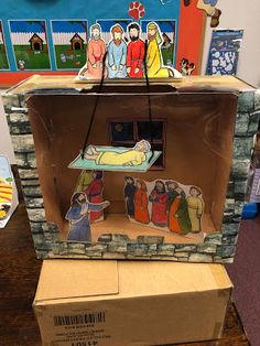 an open cardboard box with nativity scene on it