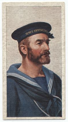 a man in a sailor's hat is looking off to the side