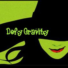 an image of a woman wearing a hat with the words defy gravity on it