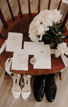 wedding stationery and shoes on a wooden chair