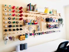 there are many craft supplies hanging on the wall