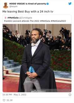 a man in a tuxedo is standing on the red carpet