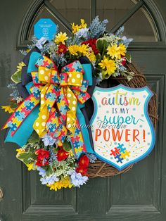 Autism is my super power!  For an autism-themed grapevine wreath measuring 20 inches, consider incorporating puzzle piece elements, as the puzzle piece is often associated with autism awareness. You could use a variety of materials and colors to represent diversity and inclusion. Bright, vibrant colors can create a visually appealing and engaging design. Adding ribbons, bows, or a sign with a positive message about autism awareness and acceptance can enhance the overall theme of the wreath. It's Wreath Ribbon, Lexington Nc, Diversity And Inclusion, Wreath Home Decor, Bead Projects, Ribbon Wreath, Puzzle Piece, Front Door Wreath, Positive Messages