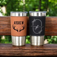 two personalized cups sitting on top of a wooden bench