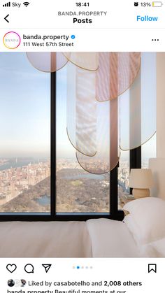 an instagramted photo of a bedroom with a view of the city from it's window