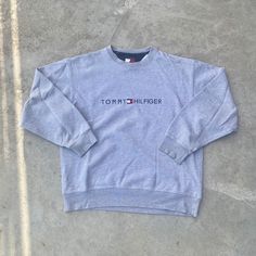 Vintage 1990s Tommy Hilfiger Gray Crewneck Sweatshirt - Size S (Length 26" Chest 22") - Fits SMALL/MEDIUM - Message for more information Please take note of the measurements listed as these are vintage clothes and may fit different than the tag size. Follow our page for more vintage clothing drops! DISCLAIMER: All items are vintage so please be mindful that if by chance there is a flaw on the item we simply may have just missed it. Inquire for more product information. 90s Long Sleeve Tops With Embroidered Logo, 90s Crew Neck Top With Embroidered Logo, 90s Style Winter Tops With Embroidered Logo, 90s Crew Neck Winter Tops, 90s Crew Neck Top For Winter, Vintage Long Sleeve Tops With Embroidered Logo, Vintage Embroidered Logo Tops For Winter, Vintage Sweater With Embroidered Logo For Fall, Tommy Hilfiger Crewneck