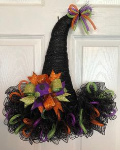 a black mesh witch's hat door hanger with orange, green and purple ribbons