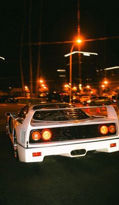 a white car parked on the street at night