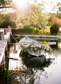 a small boat with flowers tied to it