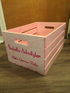 a pink wooden crate sitting on the floor