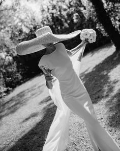 black and white photograph of woman in dress with hat