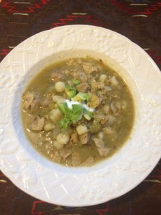 a white bowl filled with soup on top of a table