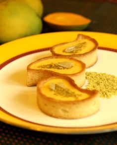 some food is sitting on a yellow and white plate with oranges in the background