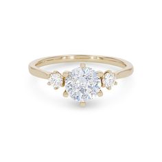 a yellow gold engagement ring with three diamonds