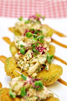 small appetizers are lined up on a plate with toothpicks and garnishes