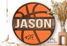 a wooden sign that says mason on it next to a vase with flowers and a basketball