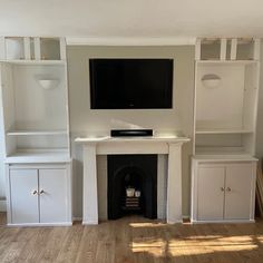 a flat screen tv mounted to the side of a wall next to a fire place