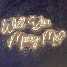 a neon sign that says will you marry me?