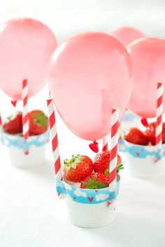 strawberries and balloons are in small cups