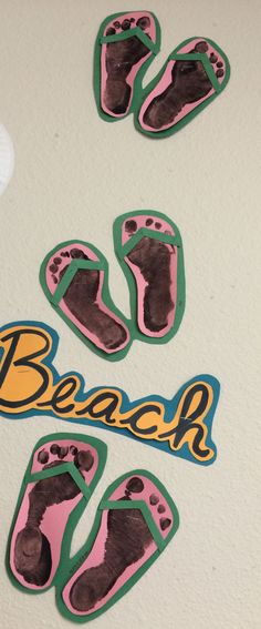 there are footprints on the wall with stickers in front of it that say beach