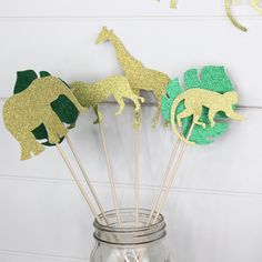 This adorable jungle centerpiece picks are sure to add an extra luxurious touch to your party!  Add these to your tables centerpieces to add some sparkle to your jungle or safari party!   These animals are generous size to really stand out on your tables!   Handcrafted here at Honeybear Party Boutique, using premium cardstock and non-shedding glitter papers!  Our glitter paper is the absolute best!  No shedding!  All of the sparkle and fun..no mess!  🌿 Our centerpiece picks are double sided so Safari Leaves, Safari Centerpieces, Decoration Jungle, Safari Baby Shower Decorations, Safari Baby Shower Boy, Baby Ellie, Jungle Safari Baby Shower, Wonderland Party Decorations, Baby Shower Safari Theme