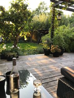 a table with two bottles of wine on top of it next to a patio area