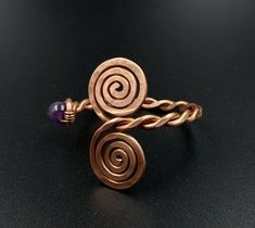 This is an adjustable, massive bracelet made of raw and pure copper with natural amethyst. Small, adjustable circumference: 16-20 cm Dacian inspiration. It can be made to order, any size. Wearing copper jewelry can leave greenish marks on the skin, that can be cleaned with soap and water. Wearing copper jewelry can stimulate healing, especially due to its ability to balance polarities or, in other words, the flow of projective and receptive energies. Nowadays, jewelry and ornaments made of pure copper are worn for healing and to prevent illness, with this therapy being called cuprotherapy. The health benefits of copper include better functioning of the body and improved health of connective tissues, hair, and eyes. It regulates the heart rate, balances the thyroid gland's function, acceler Adjustable Spiral Copper Bracelets, Adjustable Spiral Copper Bracelet, Adjustable Copper Spiral Bracelet, Adjustable Spiral Bronze Jewelry, Adjustable Bronze Spiral Jewelry, Adjustable Electroformed Purple Jewelry, Adjustable Purple Electroformed Jewelry, Wire Wrapped Jewelry Diy, Healing Jewelry