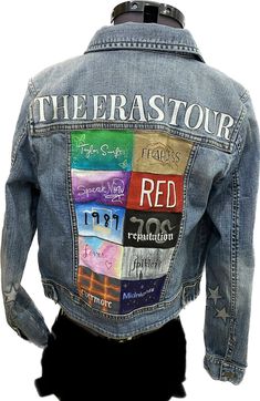 the back of a jean jacket with patches on it and words written in different colors