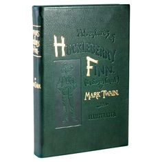 a green book with gold lettering on the front and back cover that reads, adventures of huckleberry finn