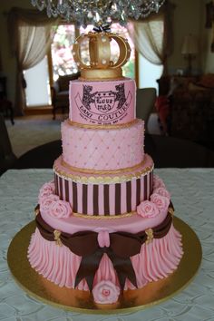 a three tiered cake with pink and brown decorations