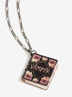 a necklace with an image of a vampire on it and the word's name