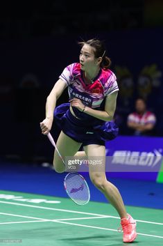 a female tennis player in action on the court at an indoor game stock - fotor