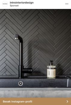 a sink with a faucet and soap dispenser next to it