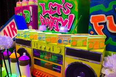 an old school boombox is decorated with tissue pom poms and spray paint