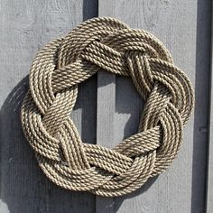 a rope hanging on the side of a wooden fence