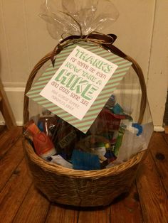 a basket filled with lots of items sitting on top of a wooden floor