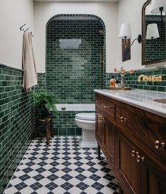 a bathroom with black and white checkered flooring