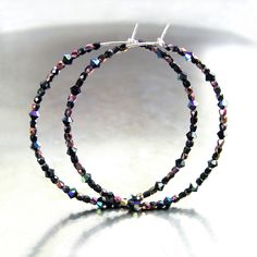 "Dainty and lightweight round hoop earrings featuring tiny (2-3mm) sparkly, faceted Swarovski and Czech crystals, in 'Black Aurora\", strung unto 21 gauge .925 Sterling Silver wire. You have a choice of 20mm, 30mm, 45mm, 55mm, 65mm or 75mm diameter hoops. More HOOP EARRINGS, in my shop: https://www.etsy.com/shop/DorotaJewelry?ref=hdr_user_menu-shop&section_id=28150357 --- All of the designs in my shop are handmade by me in my Virginia studio. Elegant GIFT BOX is included with your order YOU CAN ENTER MY SHOP HERE: http://www.etsy.com/shop/DorotaJewelry Copyright © 2025 Dorota Sularczyk. All Rights Reserved." Black Aurora, Crystal Hoop Earrings, Earrings Dainty, Czech Crystal, Beaded Hoop Earrings, Beaded Hoops, Swarovski Earrings, Earrings Boho, Silicone Beads