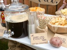 a table with potato chips, hot chocolate and soda on it for a potateto lunch