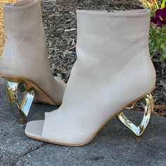 Peep-Toe Ankle Boot Gold Heart-Shaped Heel Vegan Leather True To Size Zipper Pull 3-Inch Heel Cream Glamorous Ankle Boot Heels For Spring, Spring Open Toe Boots With Sculpted Heel, Open Toe Boots With Sculpted Heel For Spring, Cream And Gold Outfit, Interesting Shoes, Marine Outfit, Peep Toe Ankle Boots, Trending Heels, Wardrobe Goals