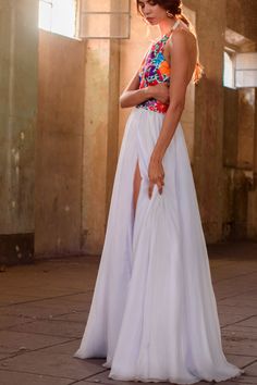 a woman in a long white dress is posing